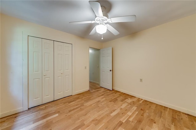 unfurnished bedroom with ceiling fan, a closet, and light hardwood / wood-style floors