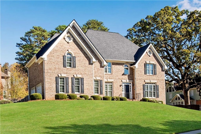 view of front of property with a garage and a front lawn