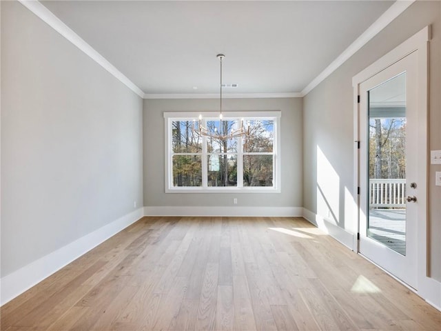 unfurnished dining area featuring a notable chandelier, light wood-type flooring, and ornamental molding