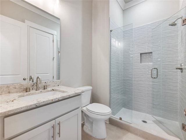 bathroom with toilet, vanity, and walk in shower