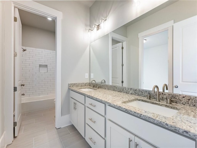 full bathroom featuring toilet, tile patterned floors, vanity, and tiled shower / bath combo