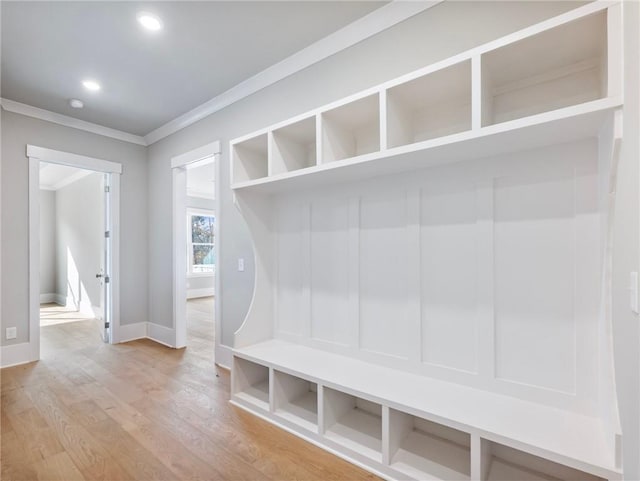 mudroom featuring ornamental molding and hardwood / wood-style flooring