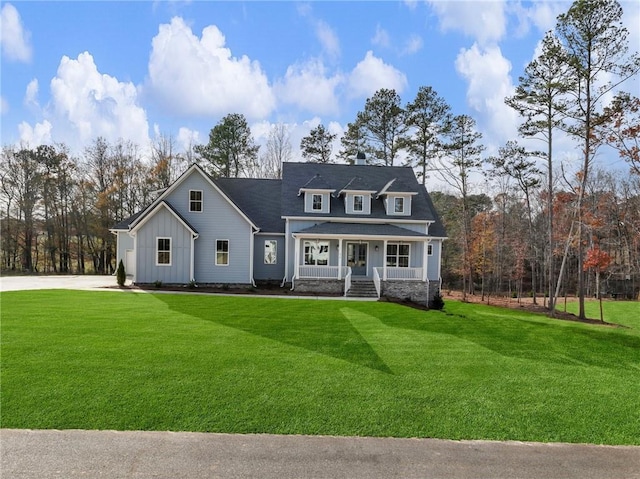 view of front of home featuring covered porch and a front yard