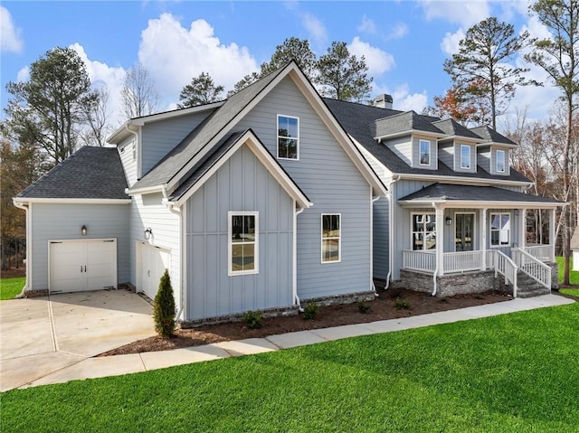 view of front of home featuring a porch, a garage, and a front lawn