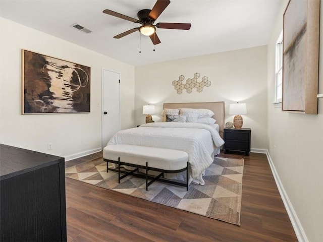 bedroom with wood finished floors, baseboards, and ceiling fan