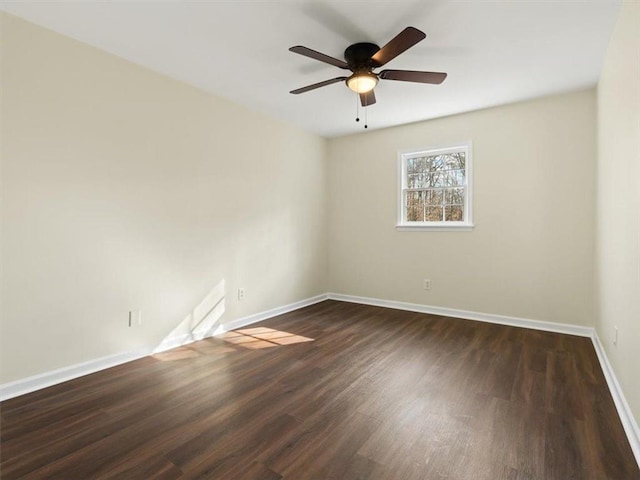 empty room with baseboards, wood finished floors, and a ceiling fan