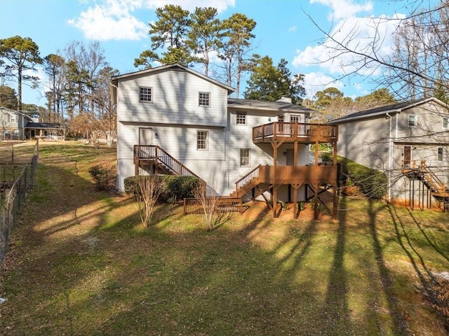 rear view of property featuring stairs and a wooden deck