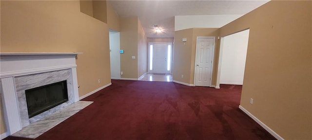 2703 Hillvale Cove Dr, Lithonia, GA 30058 - unfurnished living room featuring a high end fireplace, carpet flooring, and baseboards