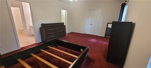 2703 Hillvale Cove Dr, Lithonia, GA 30058 - carpeted bedroom featuring ensuite bath, baseboards, and a closet