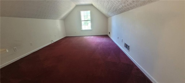 2703 Hillvale Cove Dr, Lithonia, GA 30058 - bonus room featuring carpet flooring, vaulted ceiling, baseboards, and a textured ceiling