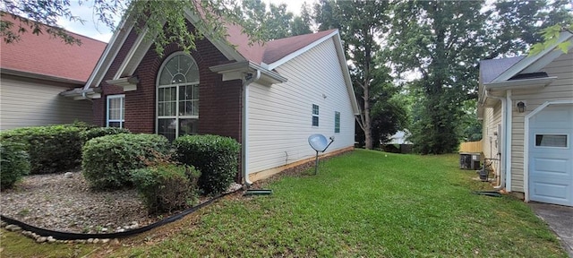 2703 Hillvale Cove Dr, Lithonia, GA 30058 - view of side of property featuring a lawn, cooling unit, a garage, and brick siding