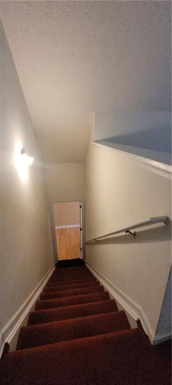 2703 Hillvale Cove Dr, Lithonia, GA 30058 - stairway featuring baseboards, carpet flooring, and lofted ceiling