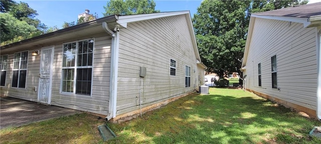 2703 Hillvale Cove Dr, Lithonia, GA 30058 - view of home's exterior with a lawn, central AC unit, and a chimney