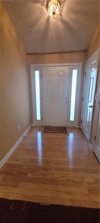 2703 Hillvale Cove Dr, Lithonia, GA 30058 - entrance foyer featuring light wood finished floors, baseboards, and a textured ceiling