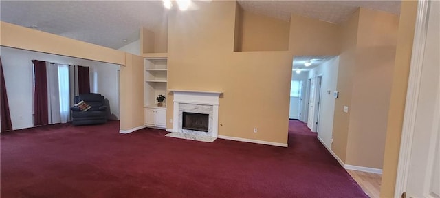 2703 Hillvale Cove Dr, Lithonia, GA 30058 - unfurnished living room featuring dark colored carpet, a premium fireplace, baseboards, and high vaulted ceiling