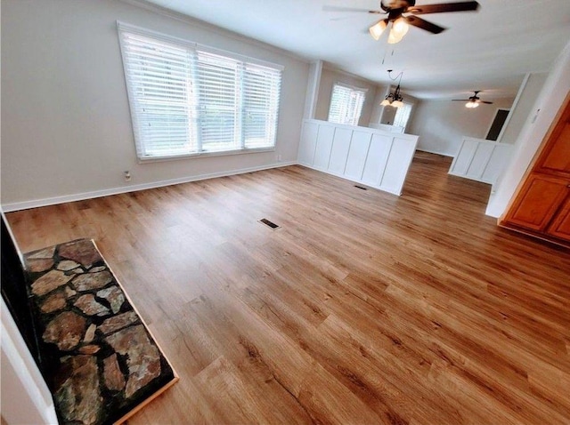 3735 Fir Dr, Buford, GA 30518 - unfurnished living room with light wood-style flooring, ceiling fan, baseboards, and visible vents