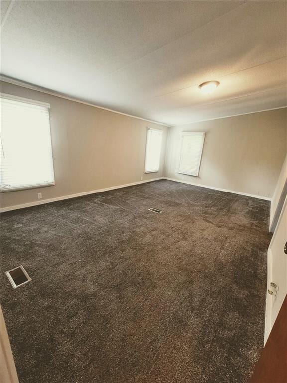 3735 Fir Dr, Buford, GA 30518 - empty room with dark carpet, visible vents, and baseboards