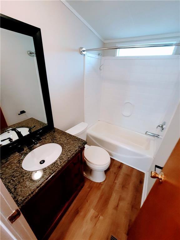 3735 Fir Dr, Buford, GA 30518 - full bath with vanity, ornamental molding, toilet, shower / bathtub combination, and wood finished floors