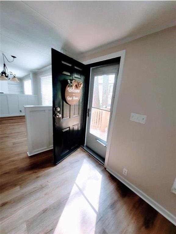 3735 Fir Dr, Buford, GA 30518 - entrance foyer with baseboards, light wood finished floors, and an inviting chandelier