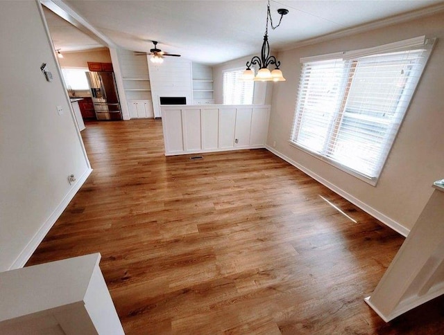 3735 Fir Dr, Buford, GA 30518 - unfurnished dining area with built in features, a ceiling fan, wood finished floors, and a fireplace