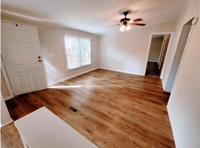 3735 Fir Dr, Buford, GA 30518 - interior space with light wood finished floors, crown molding, and ceiling fan