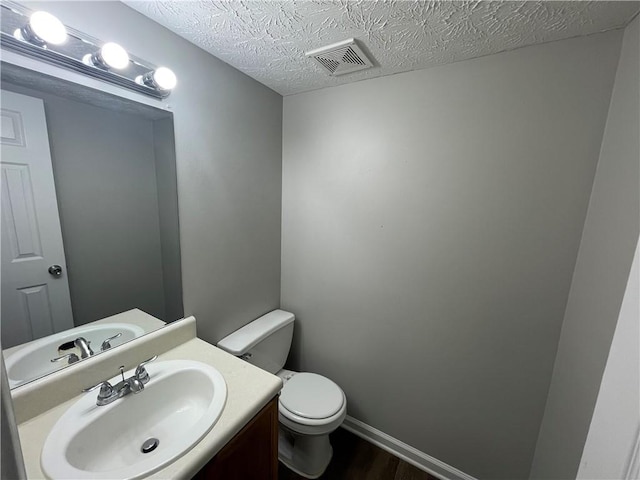 1374 To Lani Farm Rd, Stone Mountain, GA 30083 - half bathroom featuring toilet, vanity, wood finished floors, a textured ceiling, and visible vents
