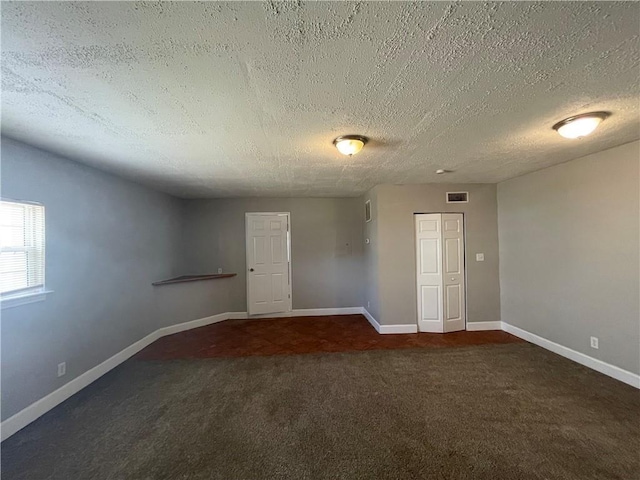 1374 To Lani Farm Rd, Stone Mountain, GA 30083 - carpeted spare room with a textured ceiling, baseboards, and visible vents