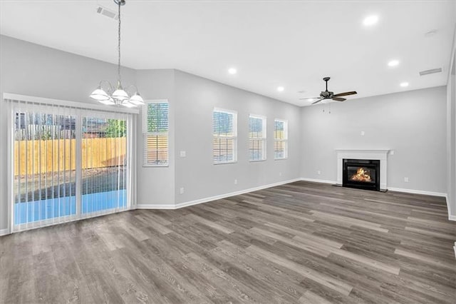 unfurnished living room with a fireplace with flush hearth, recessed lighting, baseboards, and wood finished floors