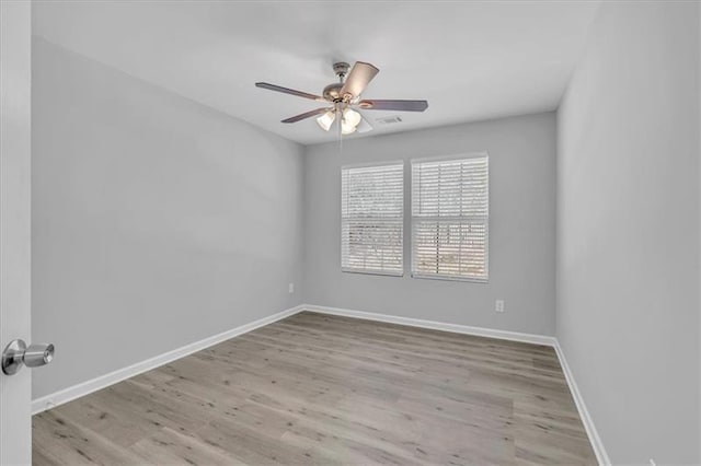 unfurnished room featuring ceiling fan, baseboards, and wood finished floors