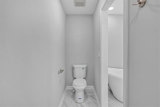 bathroom featuring marble finish floor, baseboards, visible vents, and toilet