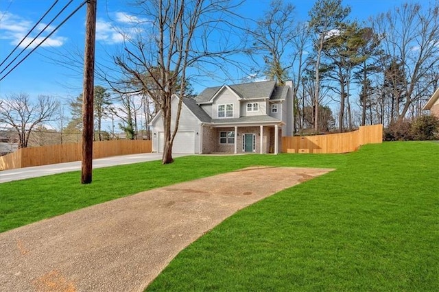 view of front of home with brick siding, fence, concrete driveway, a chimney, and a front yard