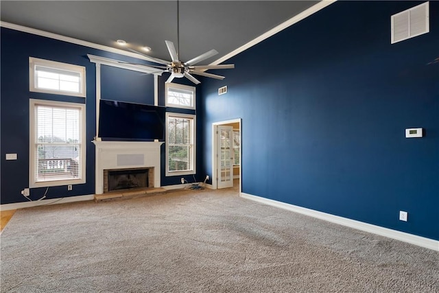 unfurnished living room with ceiling fan, carpet floors, a fireplace, visible vents, and baseboards