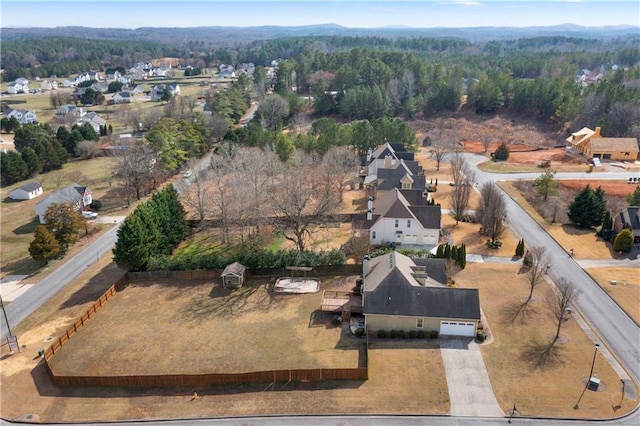 birds eye view of property featuring a wooded view