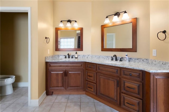 full bath featuring a sink, toilet, and tile patterned floors