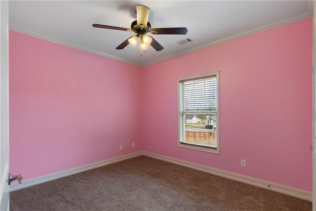 spare room featuring carpet flooring, visible vents, baseboards, a ceiling fan, and ornamental molding