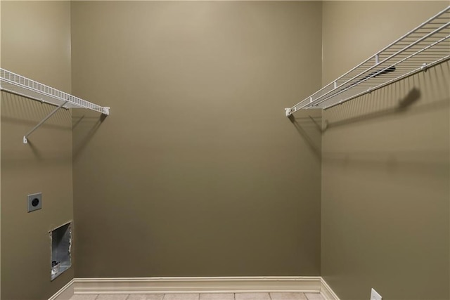 laundry room featuring baseboards, laundry area, and hookup for an electric dryer