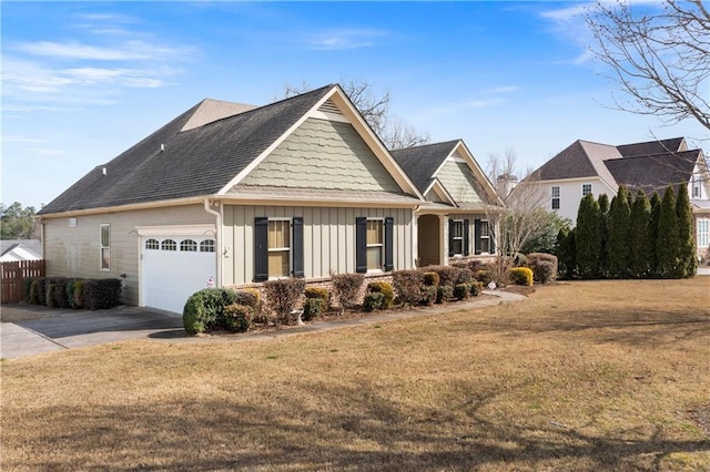 craftsman-style home featuring an attached garage, fence, driveway, board and batten siding, and a front yard