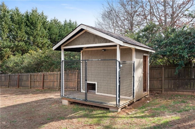 view of outdoor structure with a fenced backyard, an outdoor structure, and an exterior structure