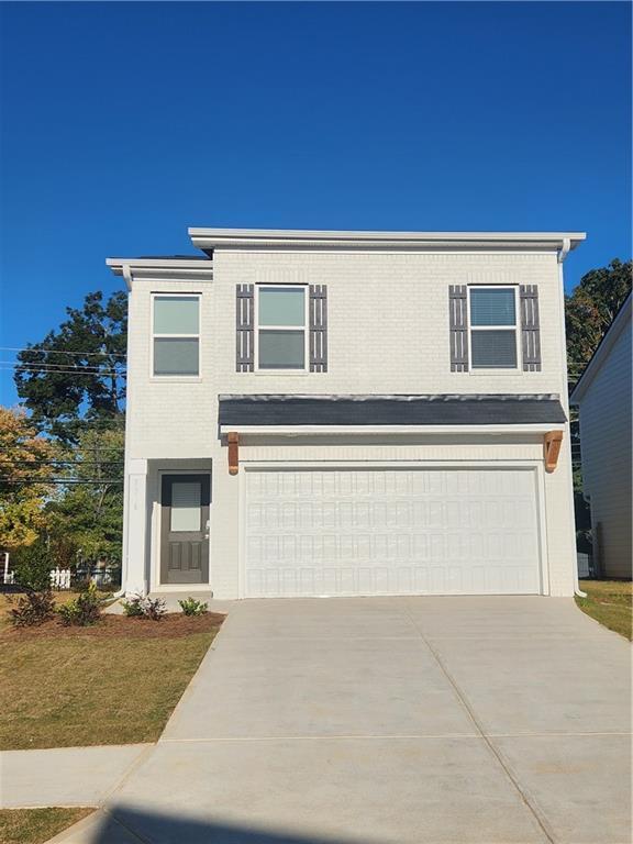 view of front of property with brick siding, concrete driveway, and a garage