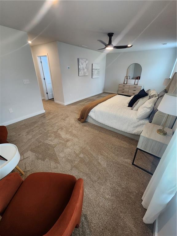 carpeted bedroom with baseboards and a ceiling fan