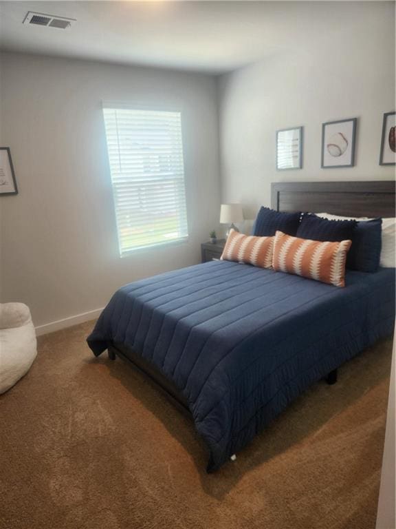 carpeted bedroom with baseboards and visible vents