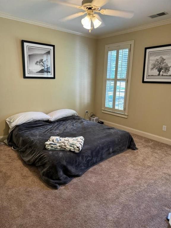 carpeted bedroom featuring ceiling fan and ornamental molding