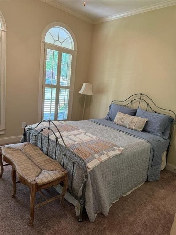 carpeted bedroom with ornamental molding