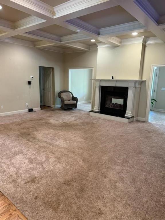 unfurnished living room with carpet, a multi sided fireplace, and ornamental molding