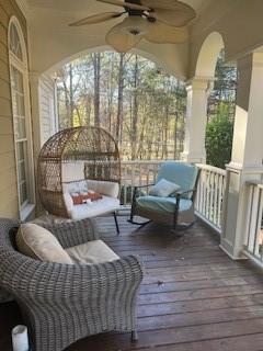 deck with ceiling fan and a porch