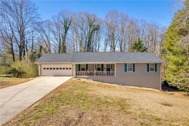 ranch-style home featuring covered porch, an attached garage, and concrete driveway