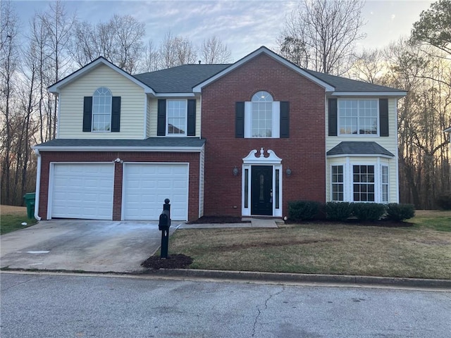 view of front of property with a front lawn, brick siding, a garage, and driveway