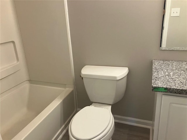 full bath with toilet, vanity, baseboards, and wood finished floors