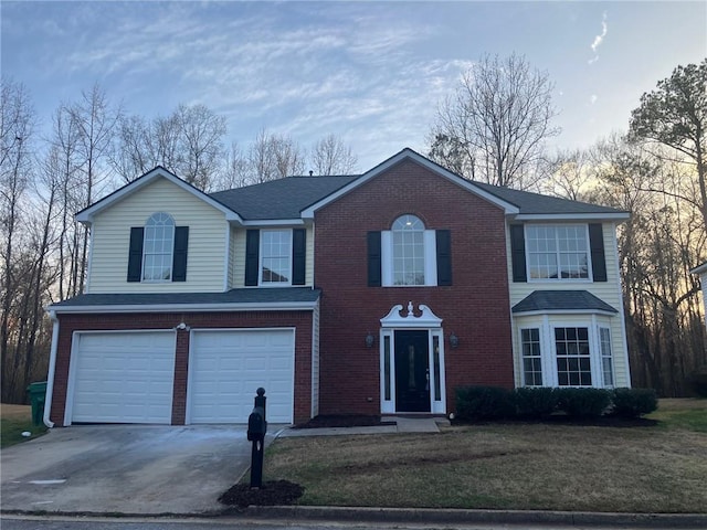 view of front of property with a front lawn, an attached garage, brick siding, and driveway