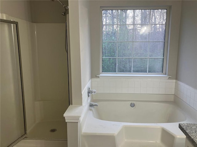 full bath with a shower stall and a garden tub